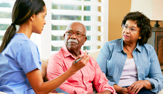 caregiver and old couple having discussion