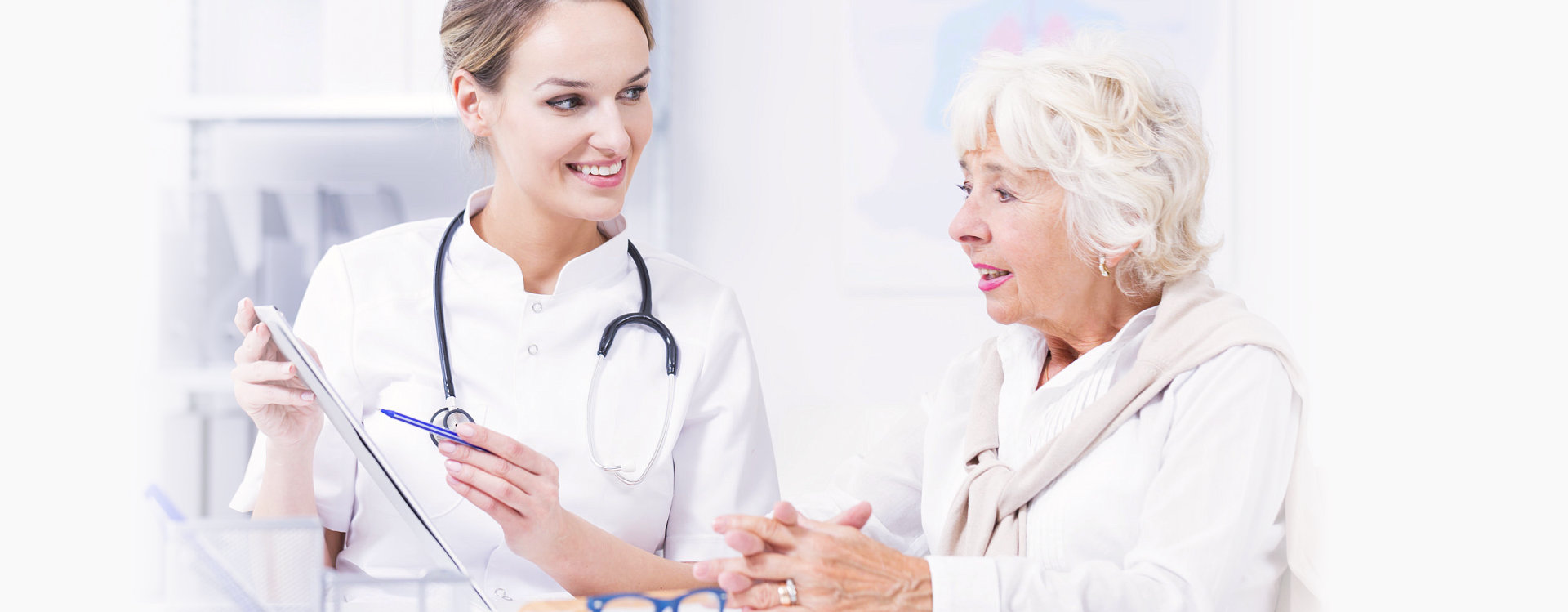 senior and nurse smiling