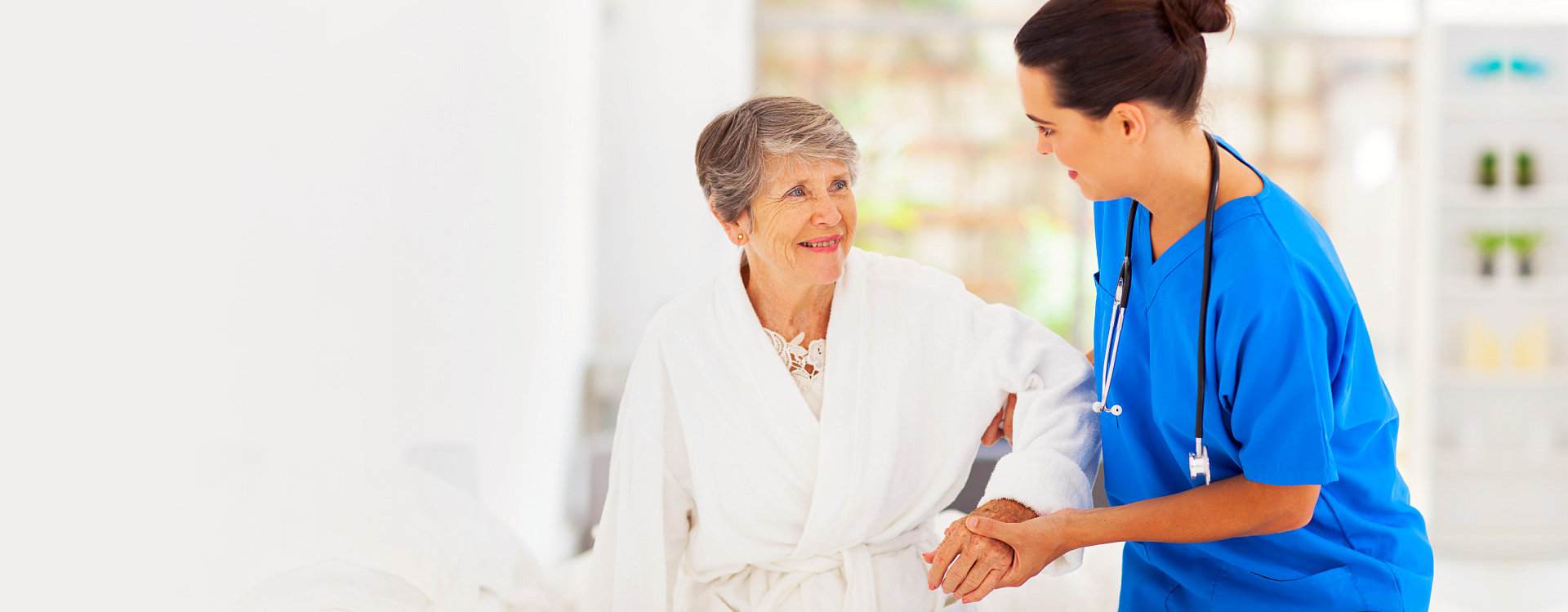 nurse assisting senior woman