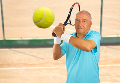 senior playing tennis