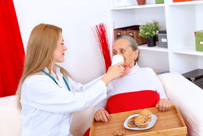 nurse helping senior eating