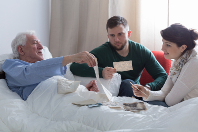 senior and caregivers looking some pictures